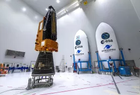 Biomass satellite on adapter with fairing shelves in the background